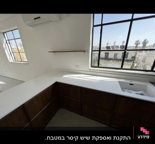 משטח שיש לבן במטבח עם כיור מובנה